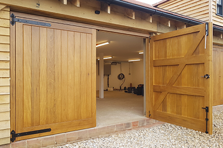 Timber side hinged garage door, vehicle and pedestrian access